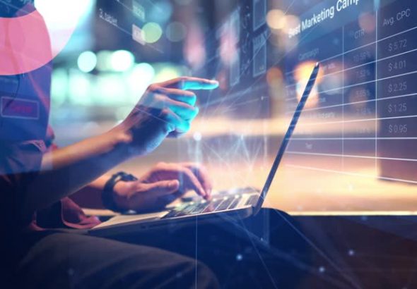 Man Using a Laptop with Business data Analytics dashboard animated overlays